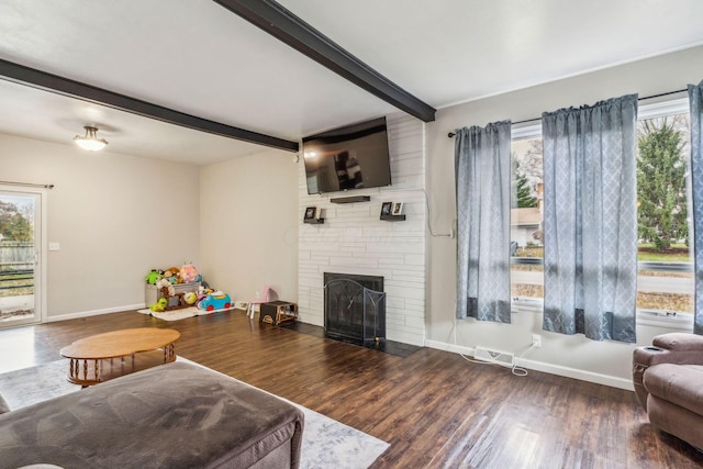 living room with beamed ceiling, dark hardwood / wood-style flooring, and a fireplace