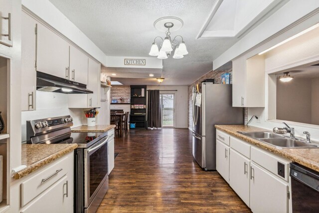 kitchen featuring white cabinetry, pendant lighting, stainless steel appliances, and sink