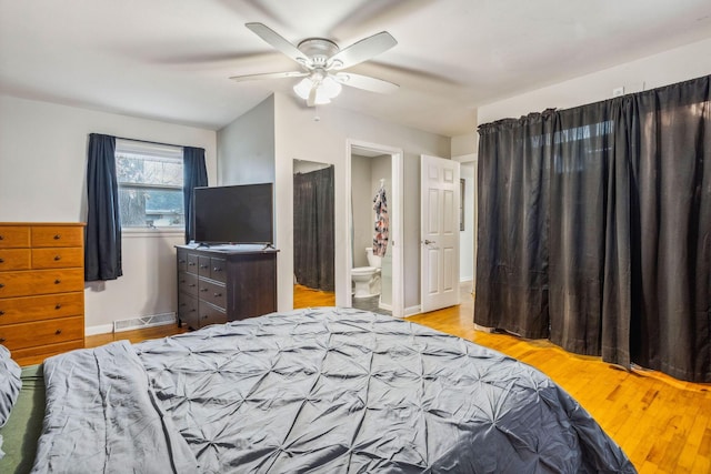 bedroom with light hardwood / wood-style floors, ensuite bath, and ceiling fan