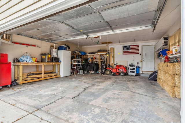 garage with a workshop area and white fridge