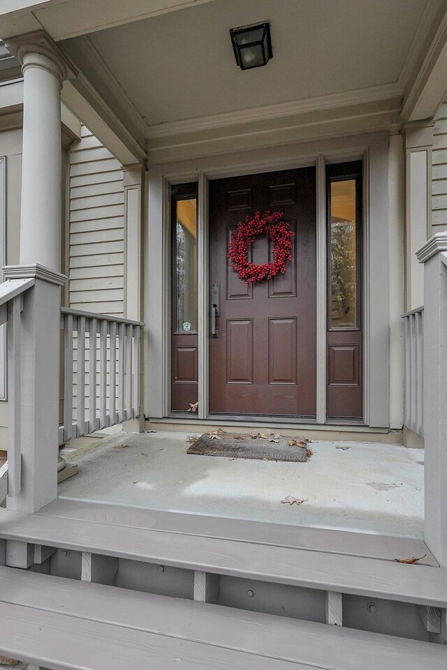 view of exterior entry with covered porch