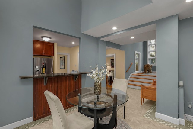 296 Walhalla Rd, Columbus, OH 43202 - dining space with light tile patterned floors, recessed lighting, and stairs