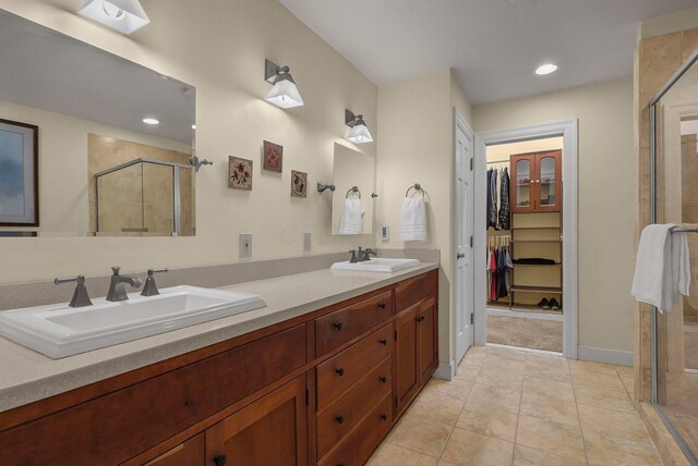 bathroom featuring tile patterned flooring, vanity, and an enclosed shower