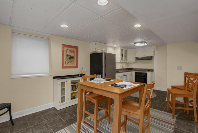 dining area with dark tile patterned floors