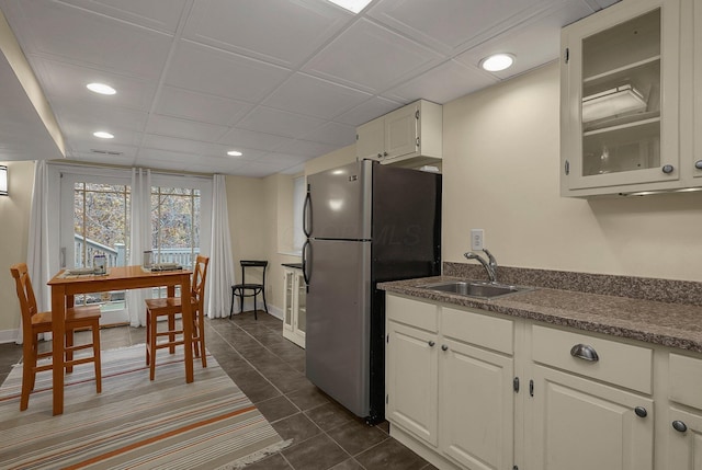 296 Walhalla Rd, Columbus, OH 43202 - kitchen with freestanding refrigerator, glass insert cabinets, white cabinetry, recessed lighting, and dark tile patterned floors