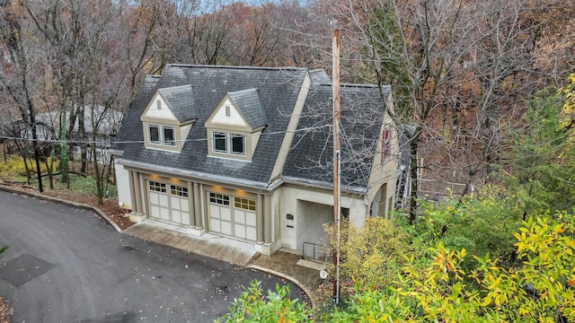 296 Walhalla Rd, Columbus, OH 43202 - view of front facade with stucco siding, roof with shingles, and asphalt driveway