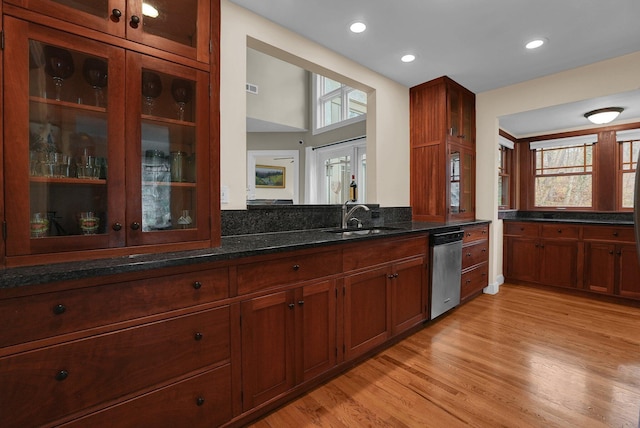 kitchen with dishwasher, light wood-type flooring, plenty of natural light, and sink