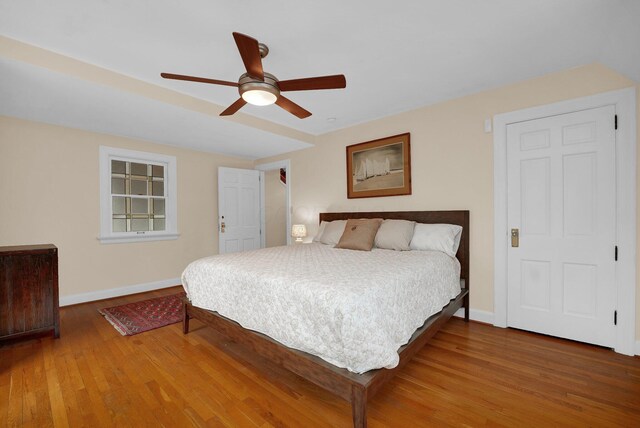 bedroom with ceiling fan and wood-type flooring