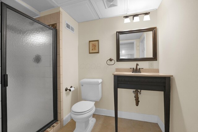 bathroom featuring toilet, sink, tile patterned flooring, and walk in shower