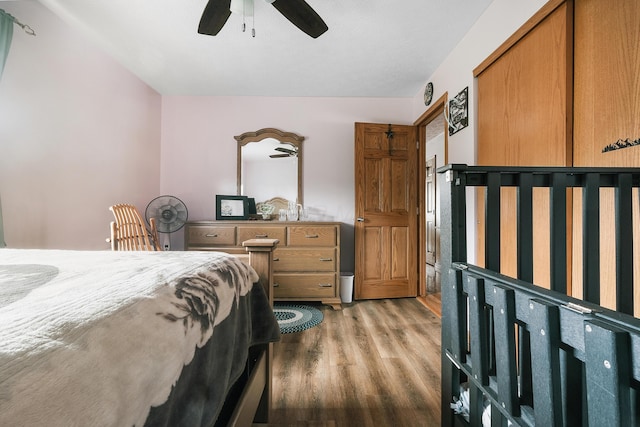 bedroom with ceiling fan and hardwood / wood-style flooring