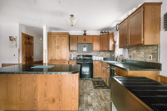 kitchen with decorative backsplash, black range with gas stovetop, a textured ceiling, and sink