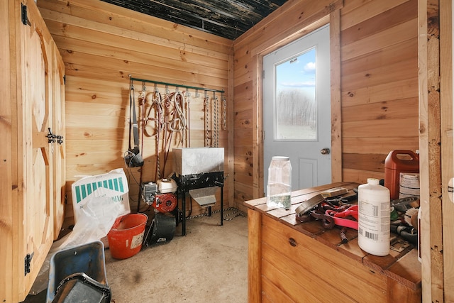 sitting room with wood walls and concrete flooring