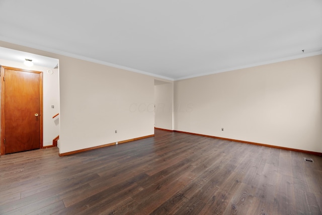 empty room with ornamental molding and dark wood-type flooring