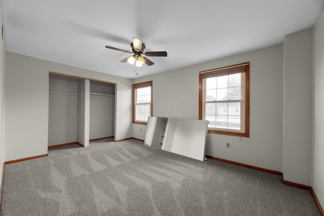 unfurnished bedroom with ceiling fan, light colored carpet, and a closet