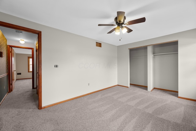 unfurnished bedroom with light colored carpet, ceiling fan, and a closet