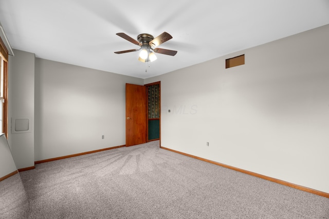 empty room featuring ceiling fan and carpet flooring