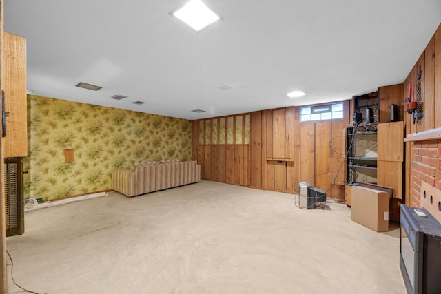 basement featuring wooden walls