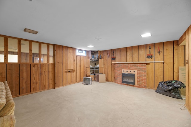 living room featuring wooden walls and a fireplace