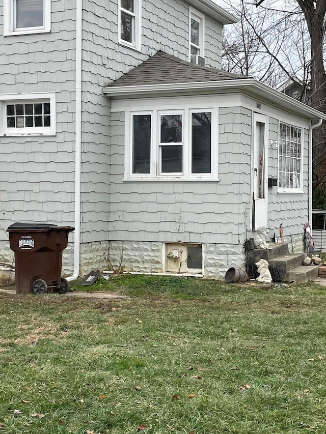 view of side of property with a lawn