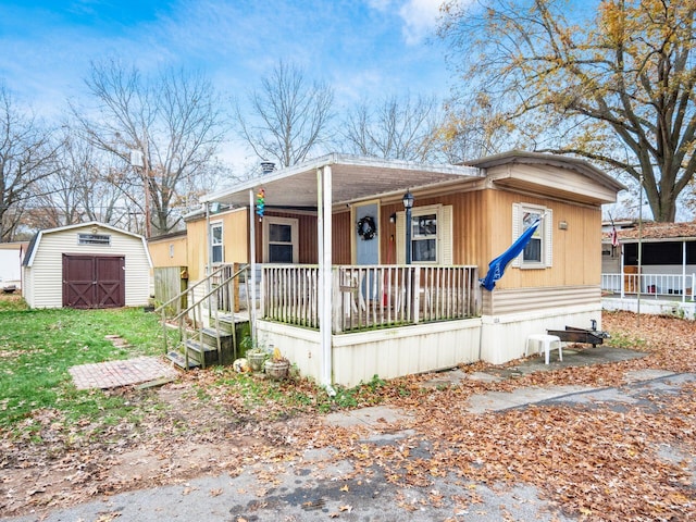 manufactured / mobile home with covered porch and a storage unit