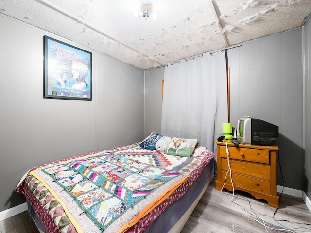 bedroom with hardwood / wood-style floors