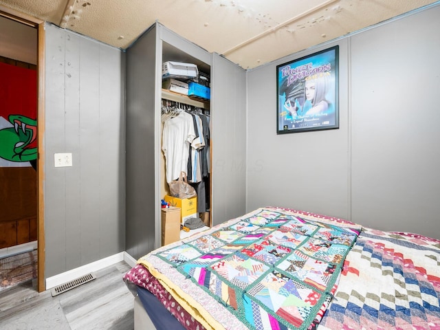 bedroom featuring wood-type flooring and a closet