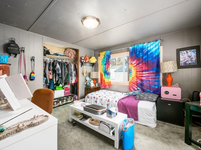 bedroom featuring light carpet and a closet