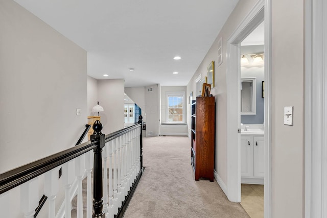 corridor featuring light colored carpet