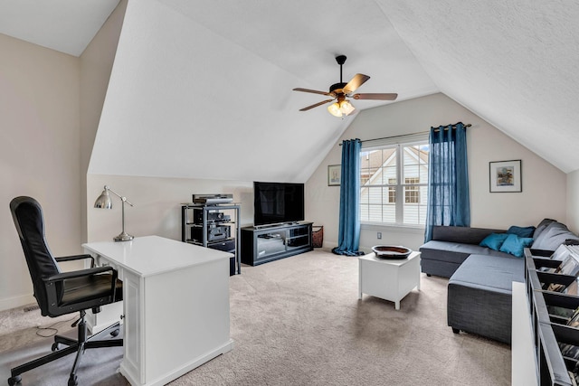 carpeted home office with ceiling fan, lofted ceiling, and a textured ceiling