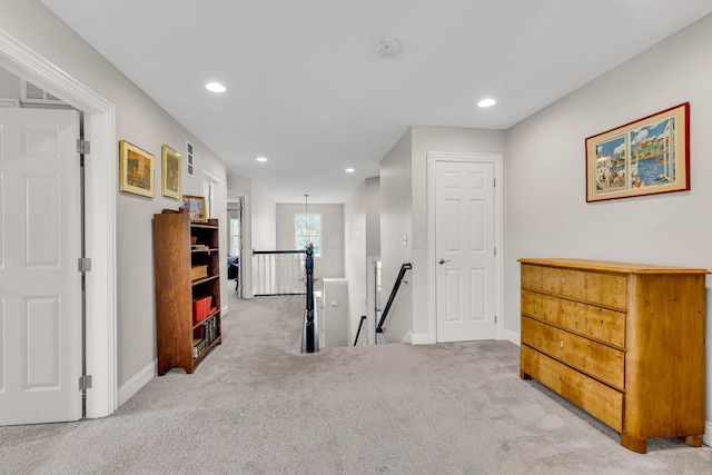 hallway featuring light colored carpet