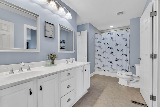 full bathroom with tile patterned floors, vanity, toilet, and shower / tub combo