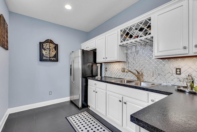 kitchen featuring white cabinetry and sink