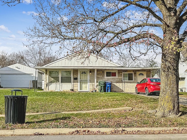 view of front facade featuring an outbuilding, a front yard, and a garage