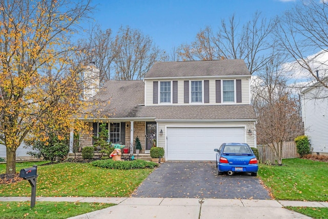 view of front facade featuring a front yard and a garage