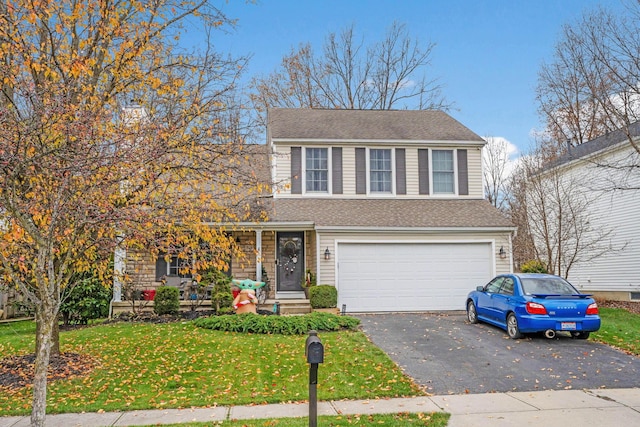 view of front of property featuring a garage and a front lawn