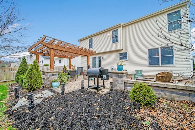 rear view of house with a pergola and a patio area