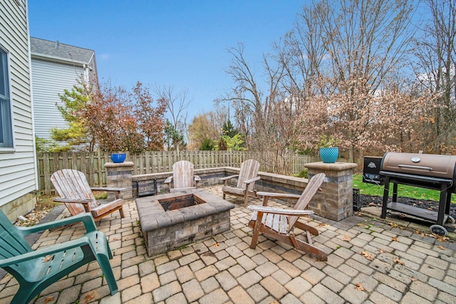 view of patio featuring a grill and an outdoor fire pit