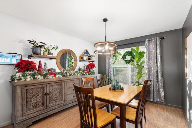 dining space featuring a chandelier and light hardwood / wood-style flooring