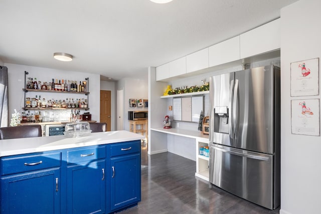 kitchen with white cabinetry, stainless steel appliances, wine cooler, dark hardwood / wood-style flooring, and blue cabinets