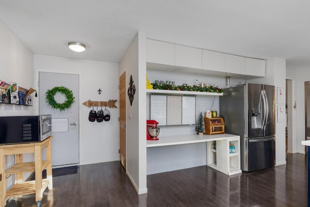 kitchen with white cabinets, dark hardwood / wood-style floors, and stainless steel appliances