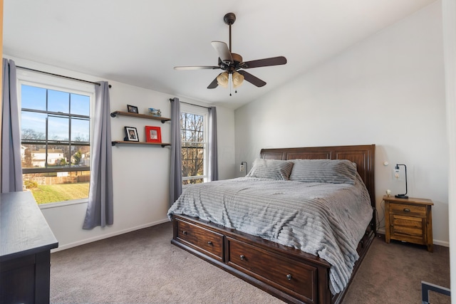 carpeted bedroom featuring multiple windows, lofted ceiling, and ceiling fan