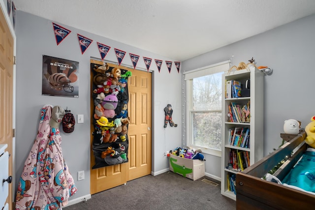 rec room featuring dark colored carpet and plenty of natural light