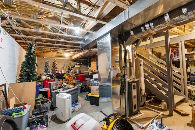 basement featuring heating unit and water heater