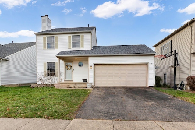 view of property featuring a garage and a front yard