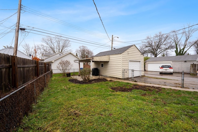 view of yard featuring a garage and an outbuilding