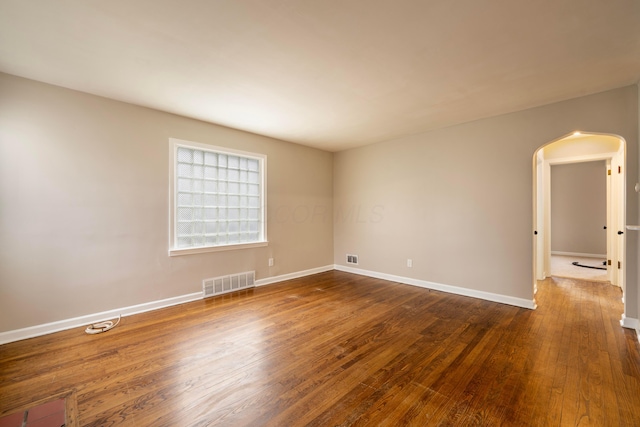 unfurnished room with dark wood-type flooring