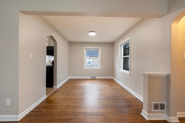 spare room with dark hardwood / wood-style flooring