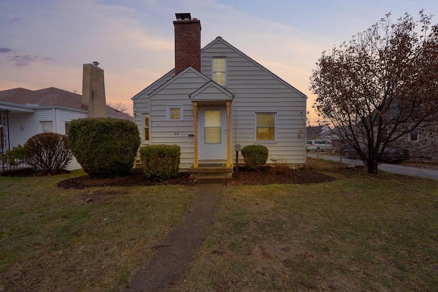 bungalow-style home featuring a lawn