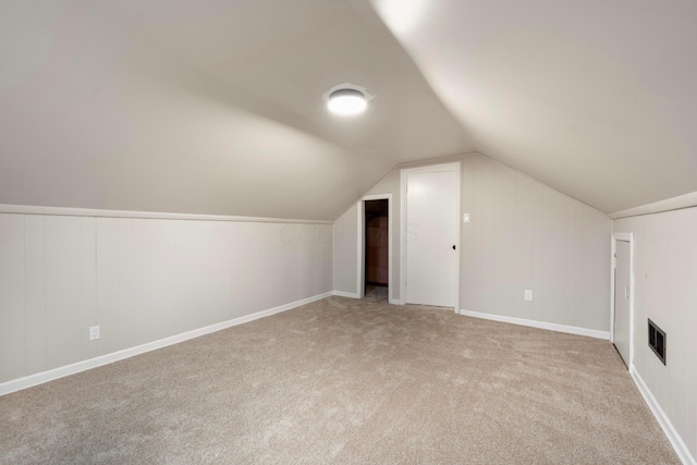 bonus room featuring light carpet and lofted ceiling