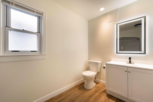 bathroom featuring hardwood / wood-style floors, vanity, and toilet